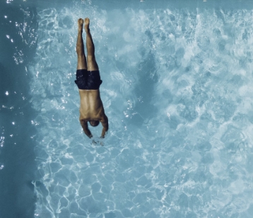 man diving into pool